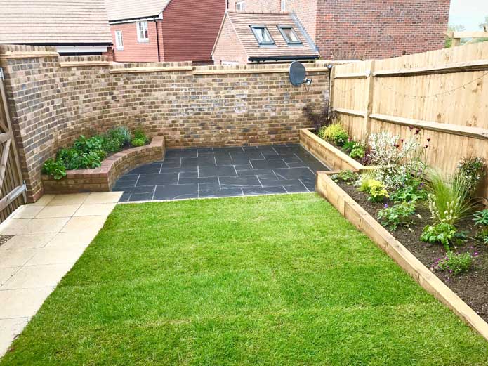 A small garden patio with low walls built around it